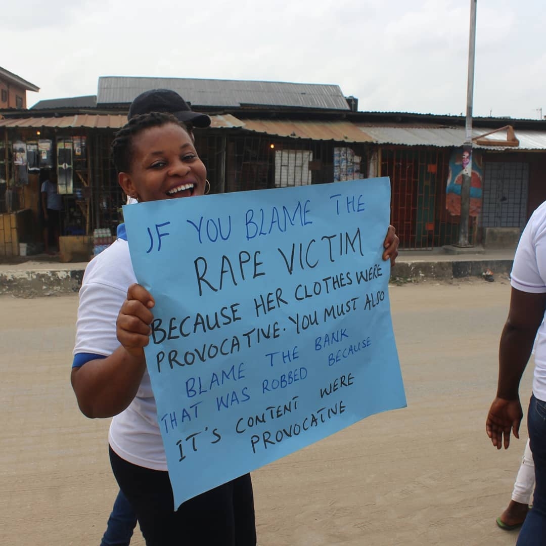 OLIC campaigner holding an awareness placard