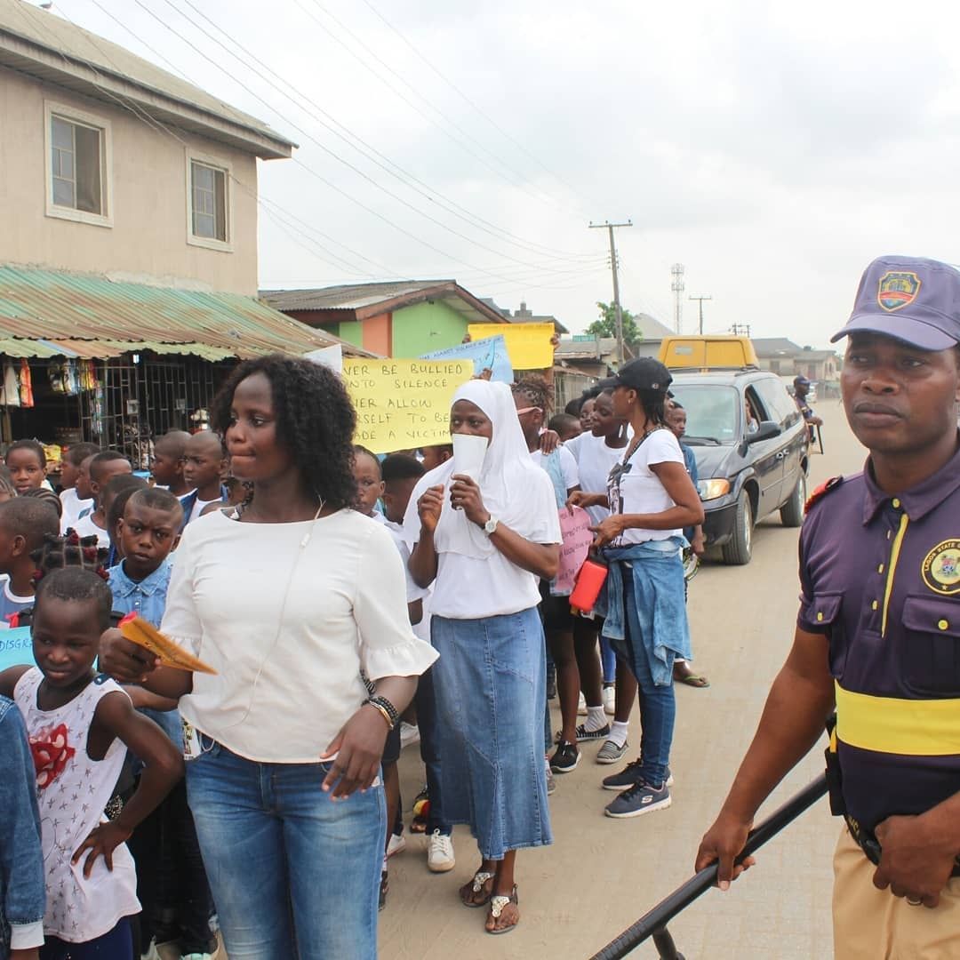 OLIC volunteers leading a community awareness march in Iba, Lagos